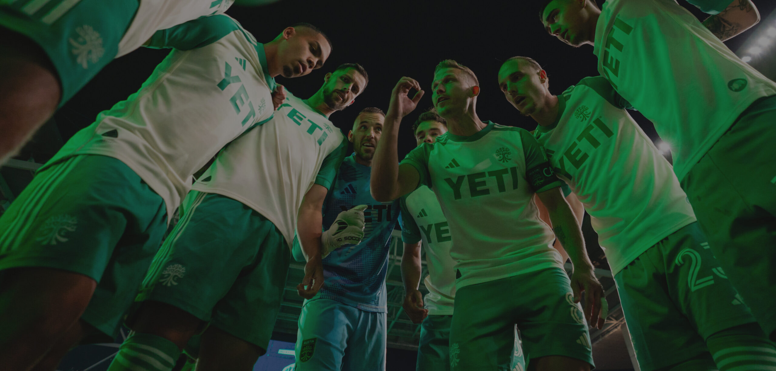 inside an Austin FC players huddle