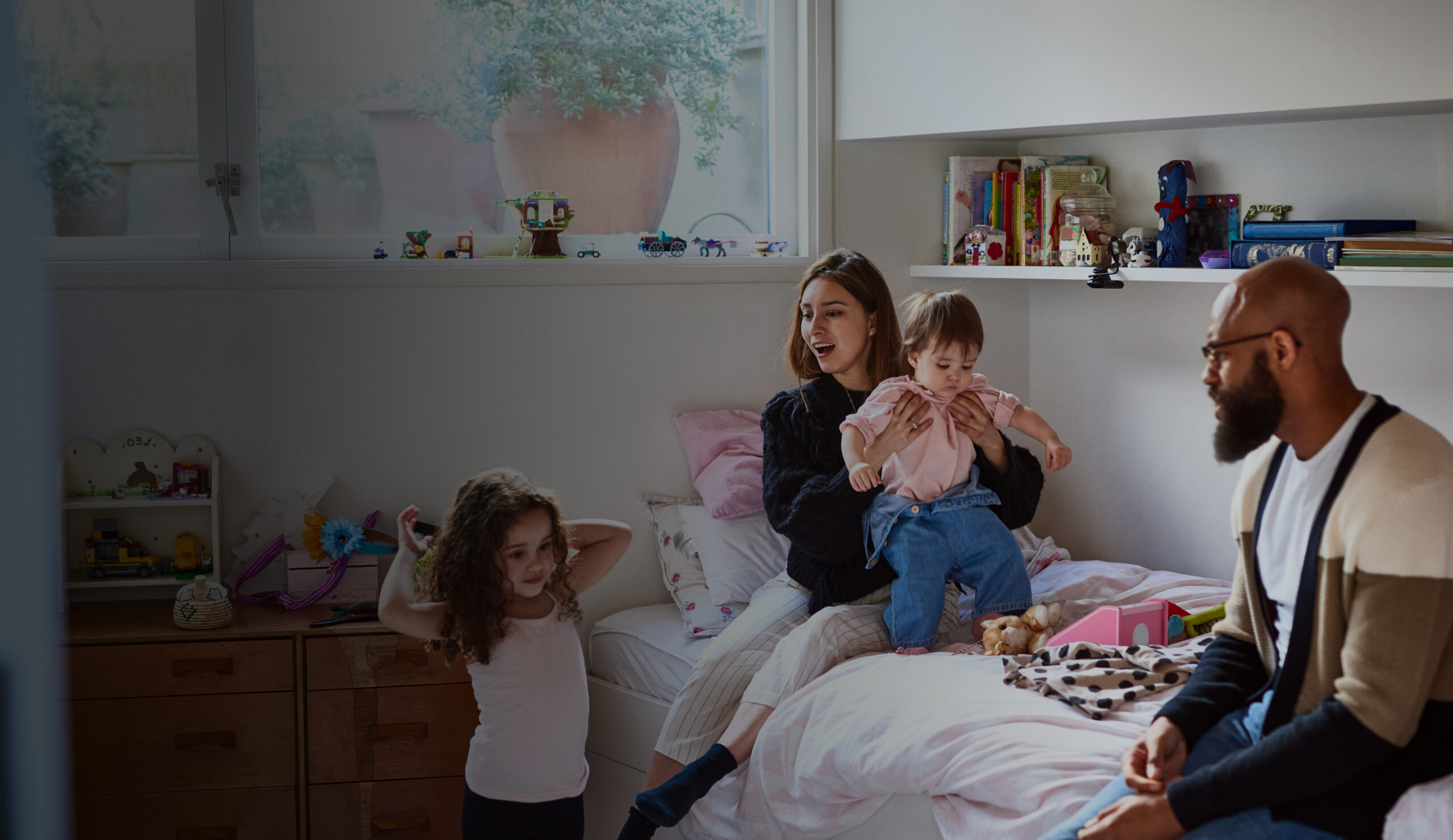 Parents sitting on the floor playing with their child