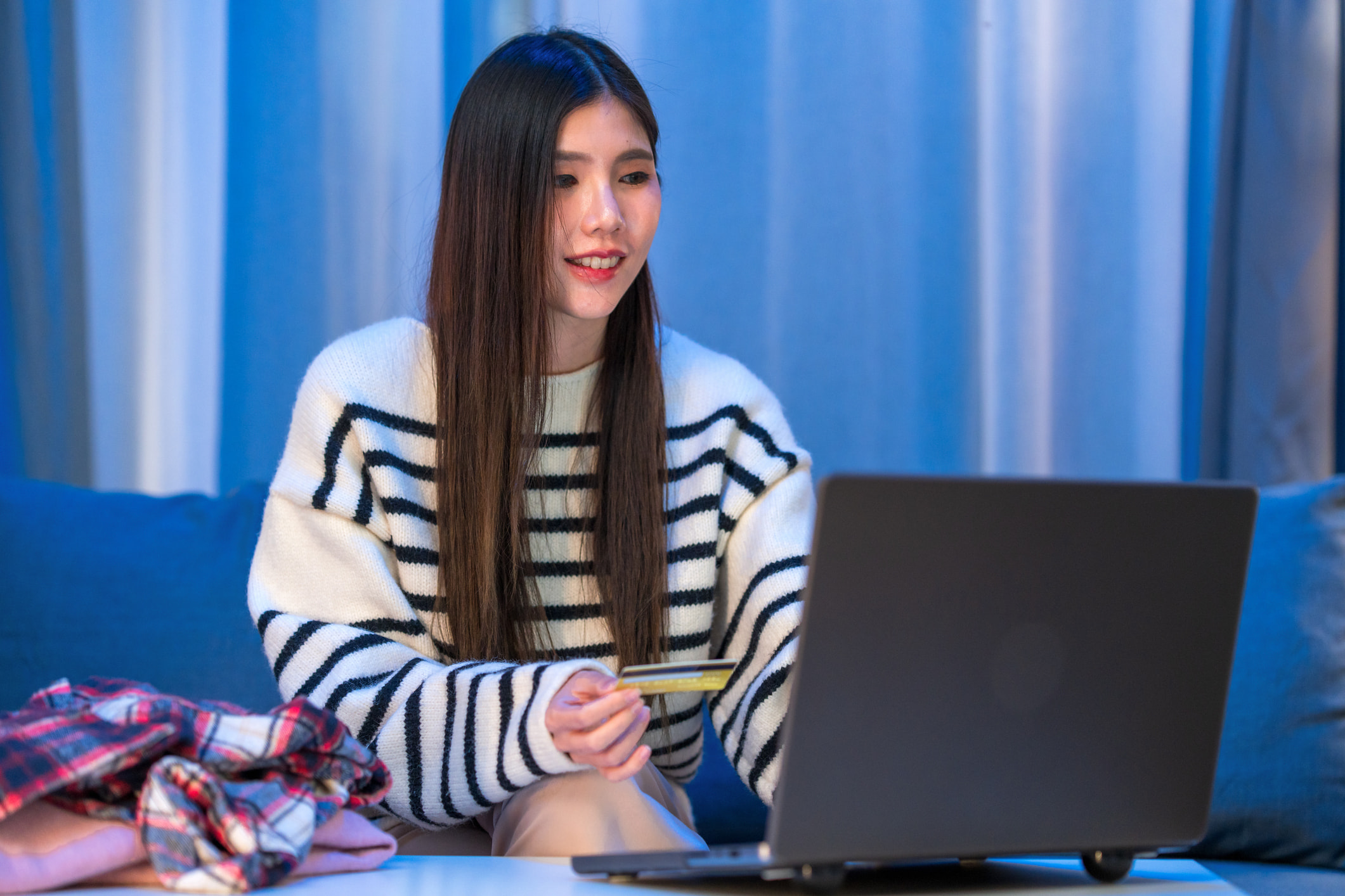 Young woman banking online on laptop at home