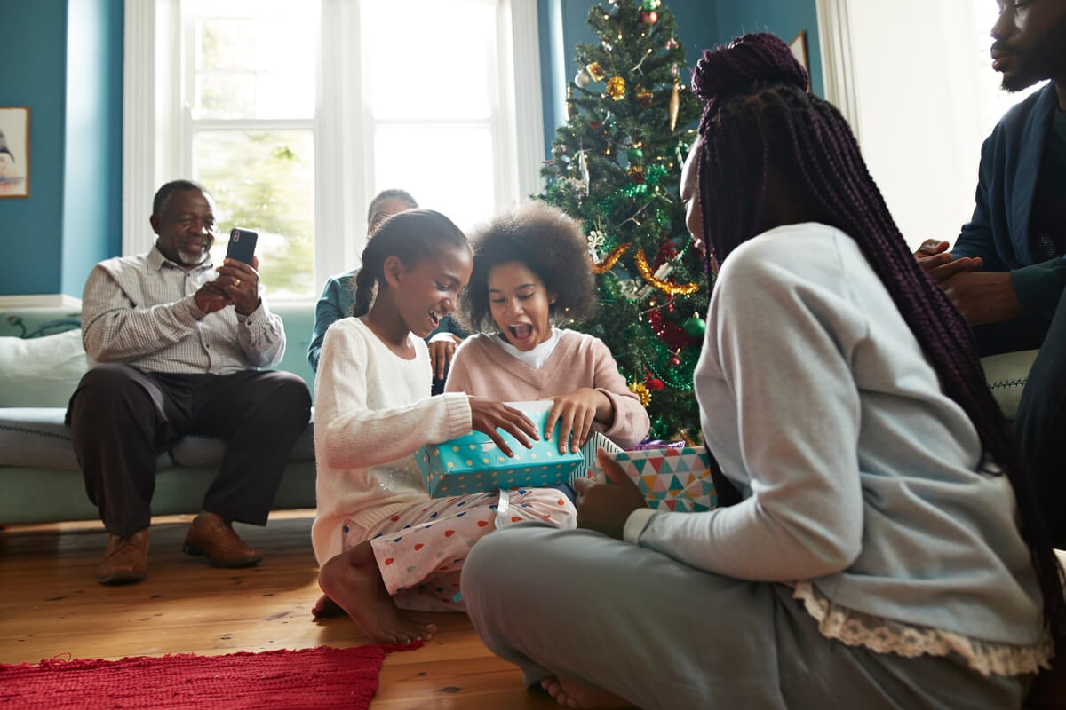 A family opening up budget-friendly Christmas gifts.